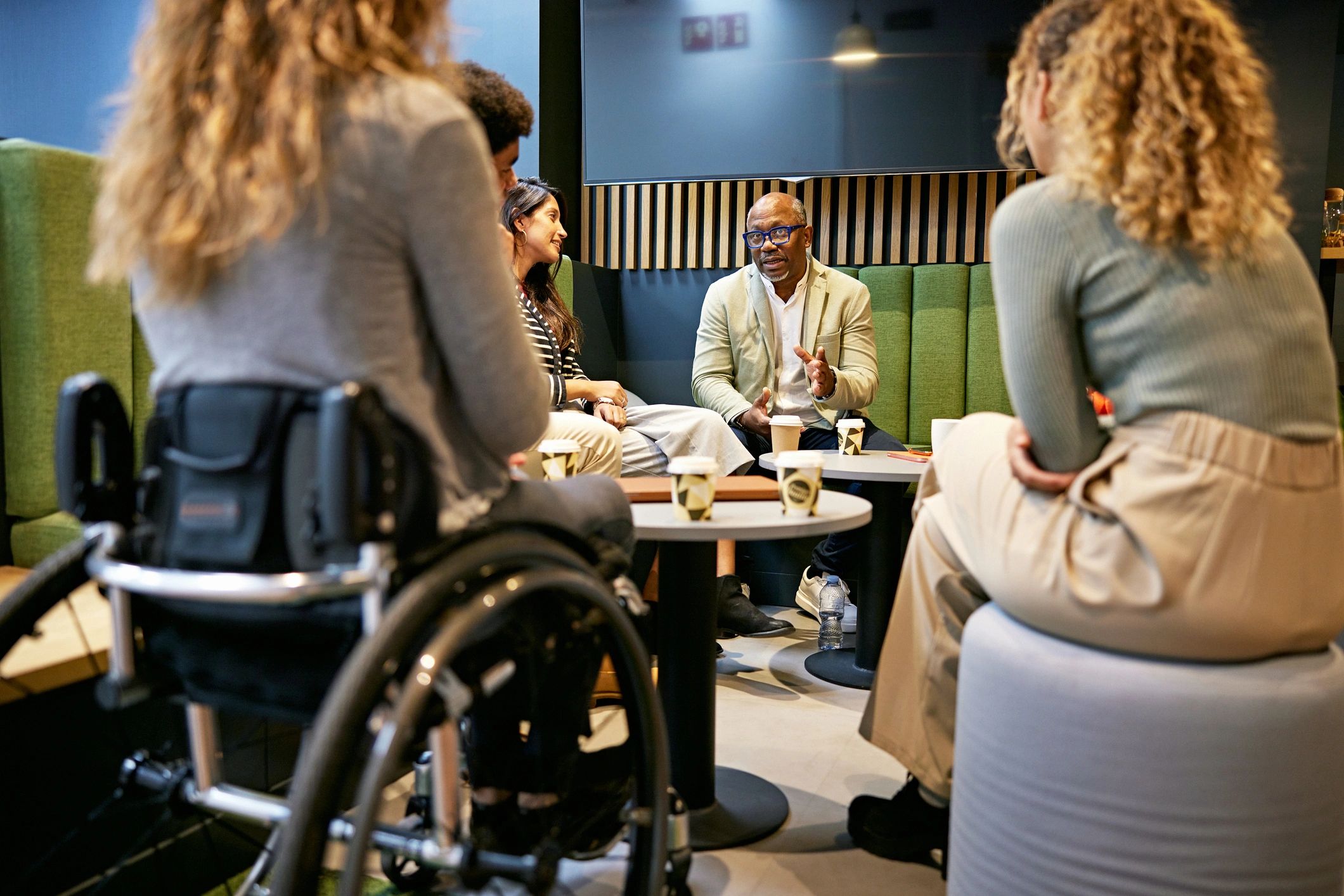 Consulting team meeting and discussing strategy in a relaxed office setting